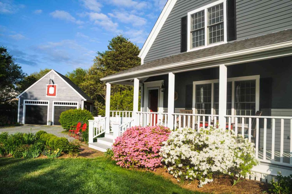 a beautiful red bush in front of house