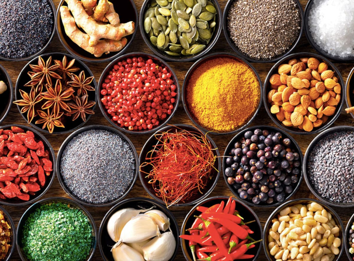 A colorful assortment of Indian spices and herbs displayed in bowls