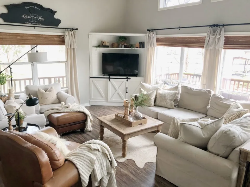 An inviting living room featuring white furniture and a television, designed with children in mind