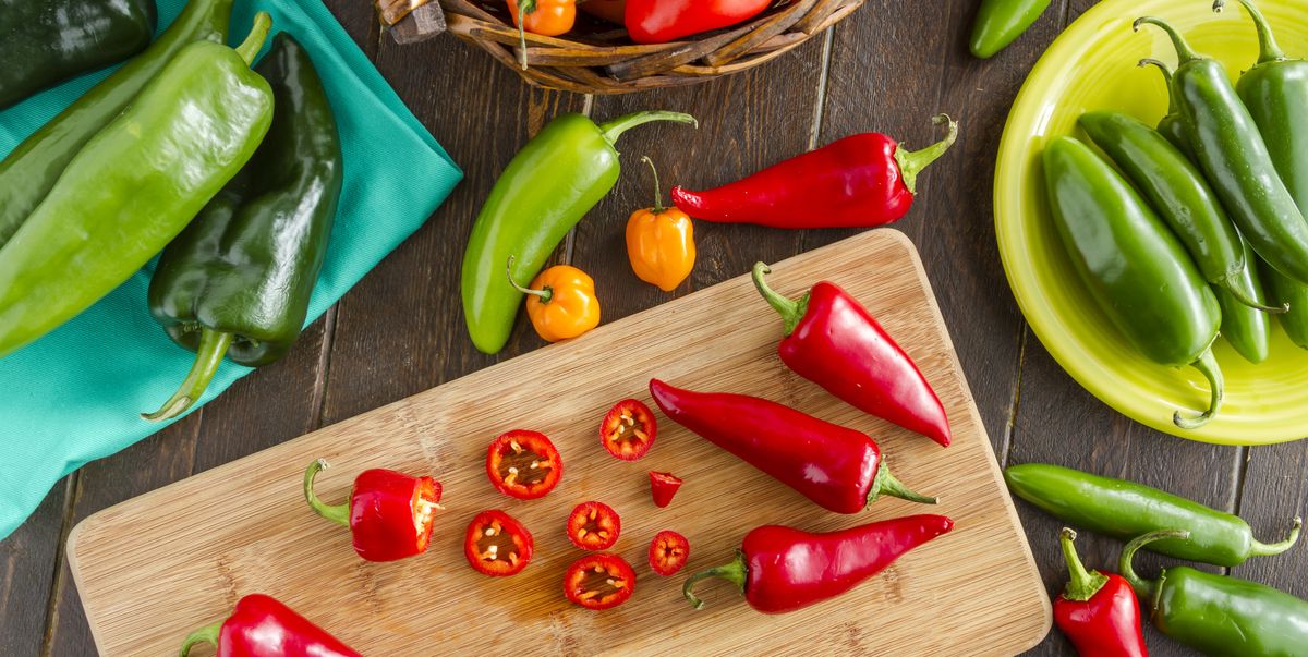 A cutting board with a colorful assortment of peppers