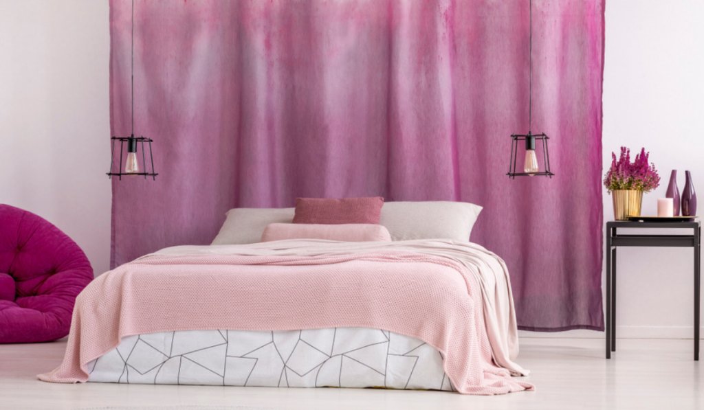 A cozy pink bedroom with a comfortable bed