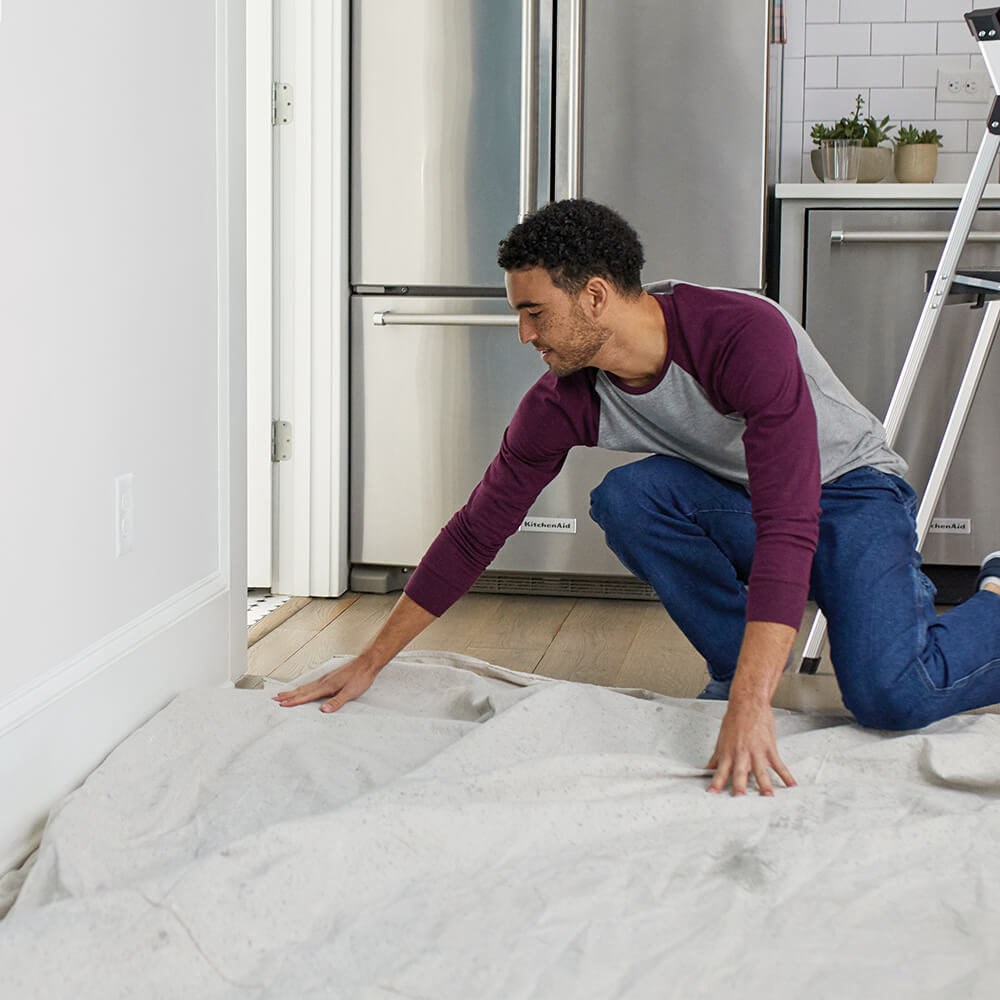 man preparing his workspace on the floor in a room