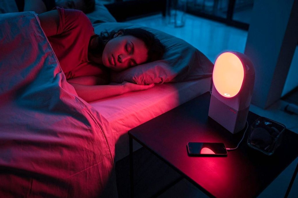 A woman peacefully sleeping in a red-lit bedroom