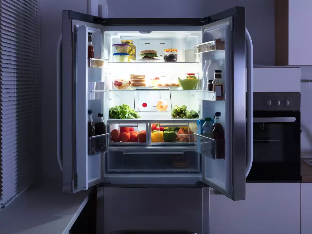 Refrigerator with open door and food inside, ready to be stored safely