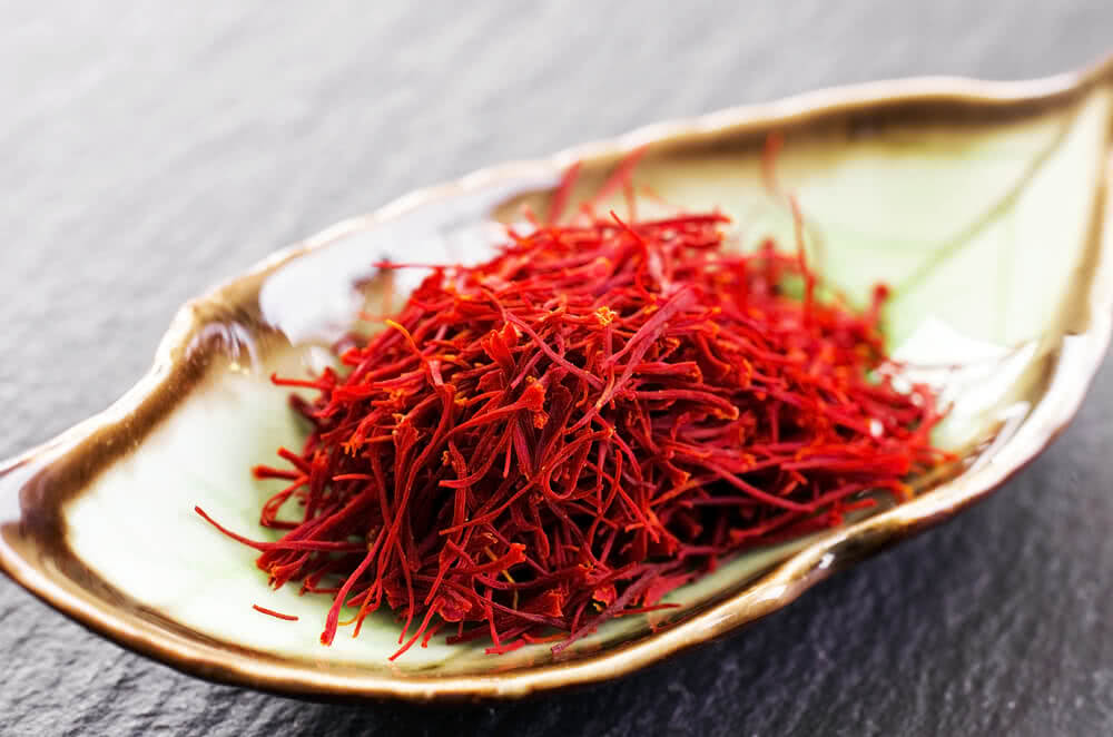 A bowl filled with vibrant red saffron