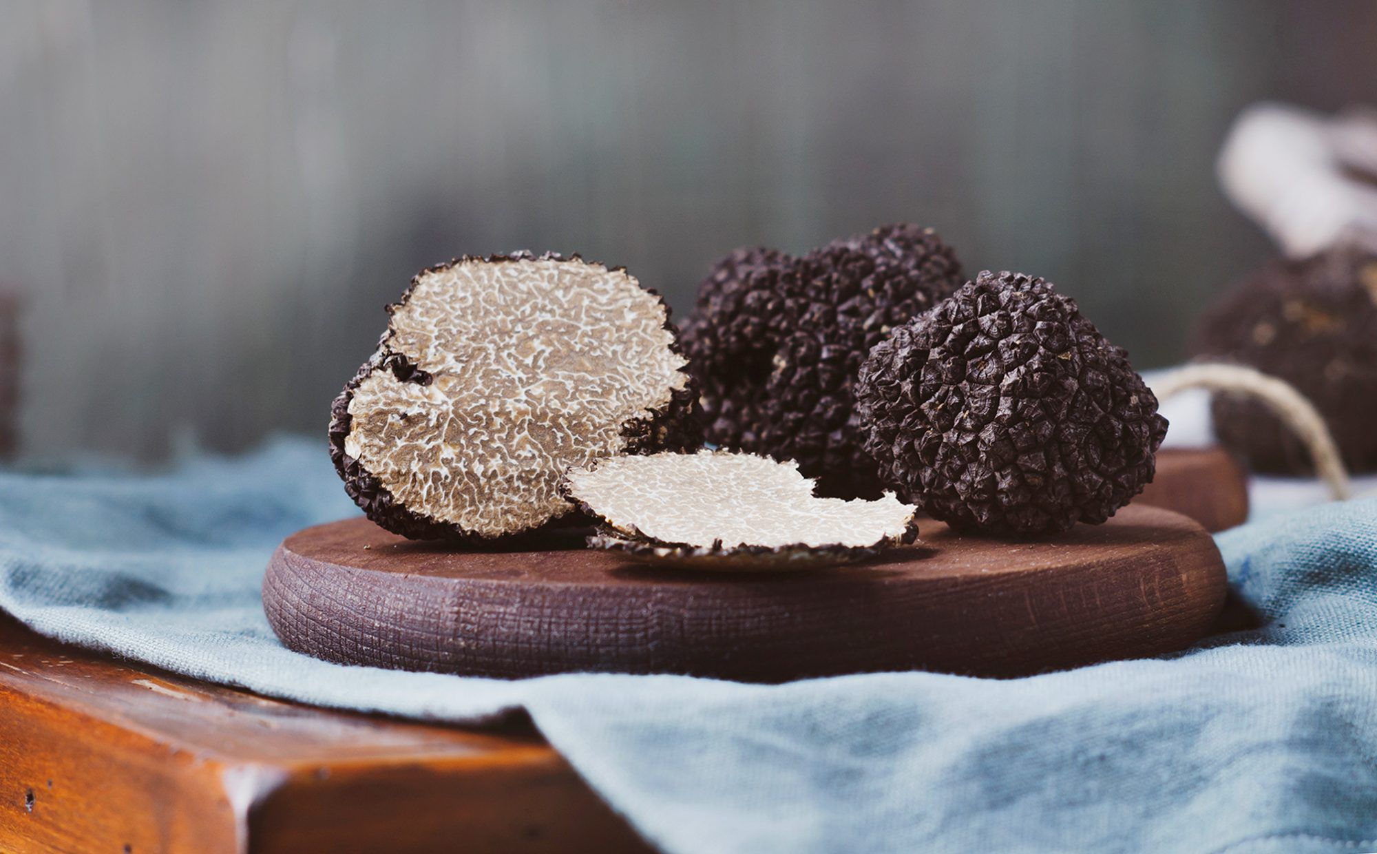 black truffles arranged on a wooden board