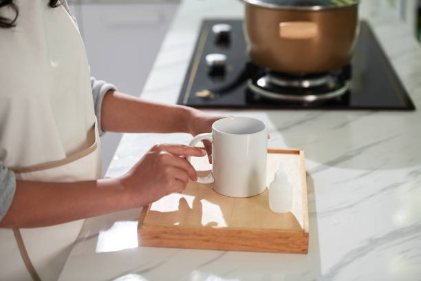 Closeup image of woman glueing broken mug