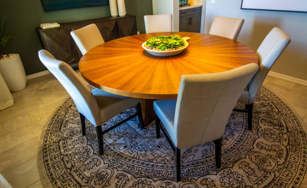 A round dining table with six chairs and a bowl, perfect for small spaces