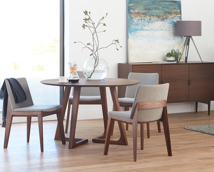 A contemporary dining room featuring a wooden table and chairs, designed with no sharp edges