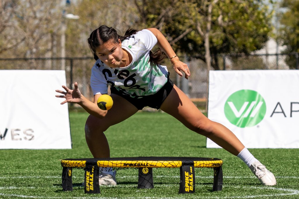 a girl playing spikeball